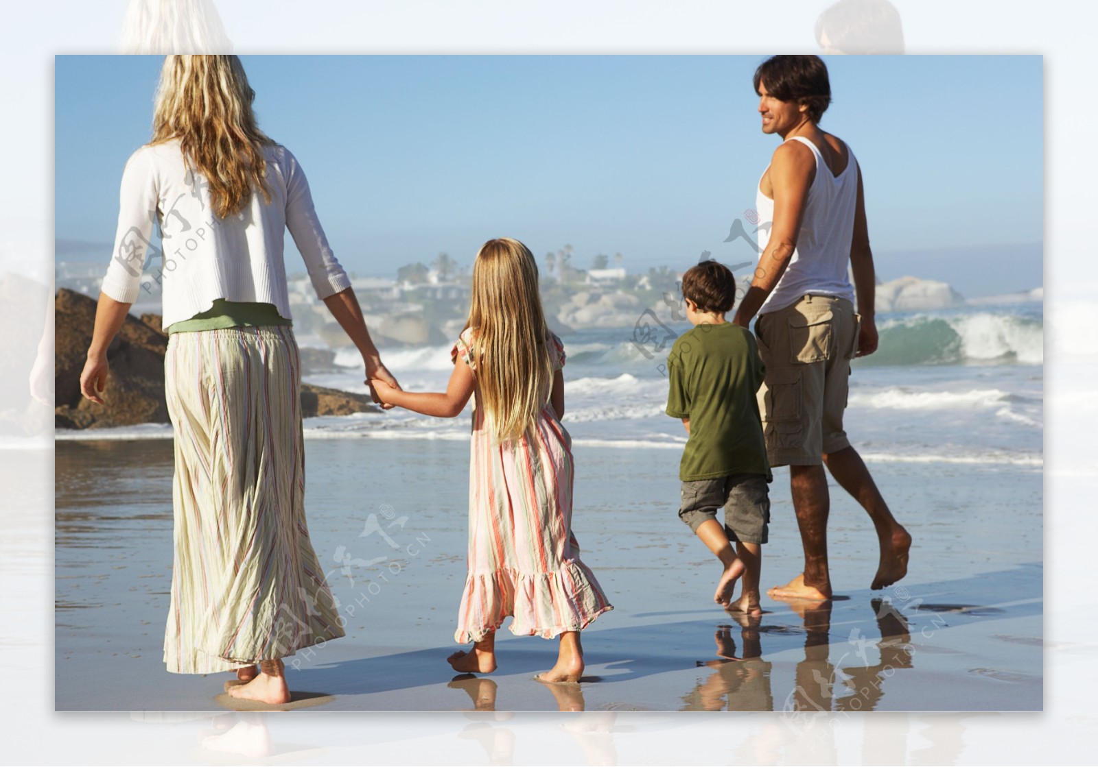 正在海边散步的一家人图片