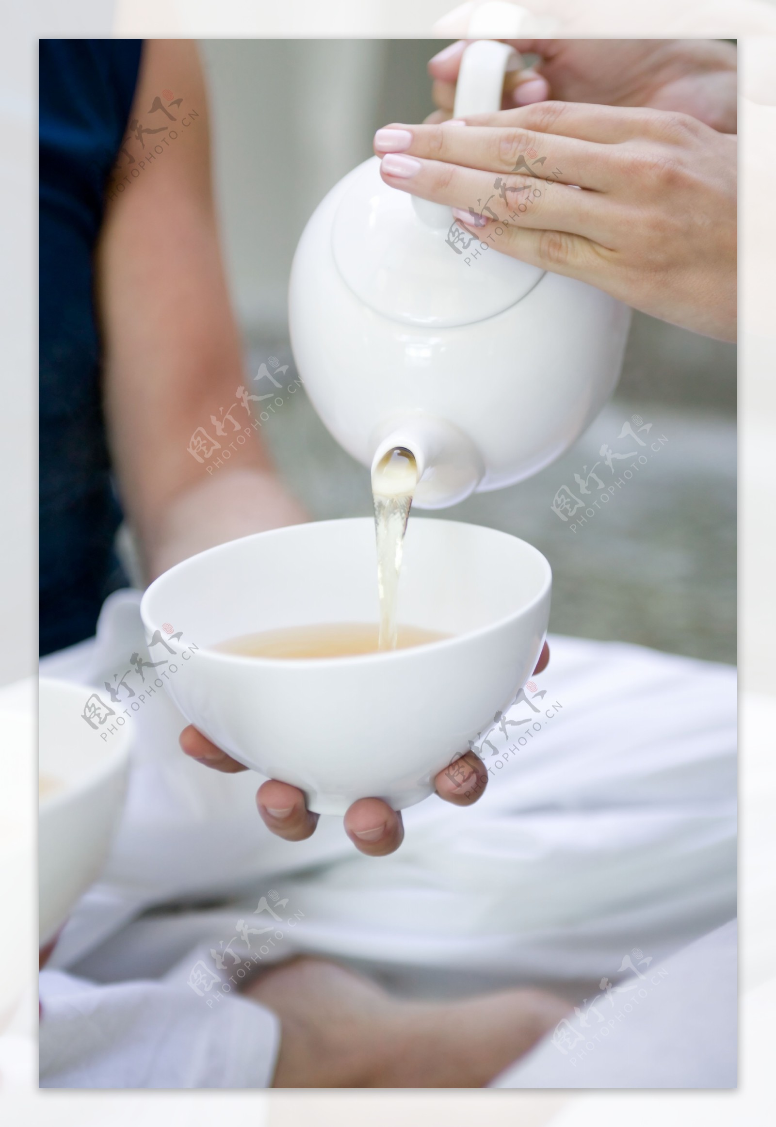 从茶壶里向碗里倒茶图片